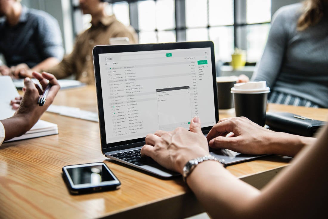 Journalist typing an email